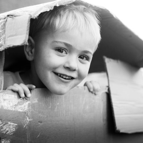 photo of boy in cardboard box