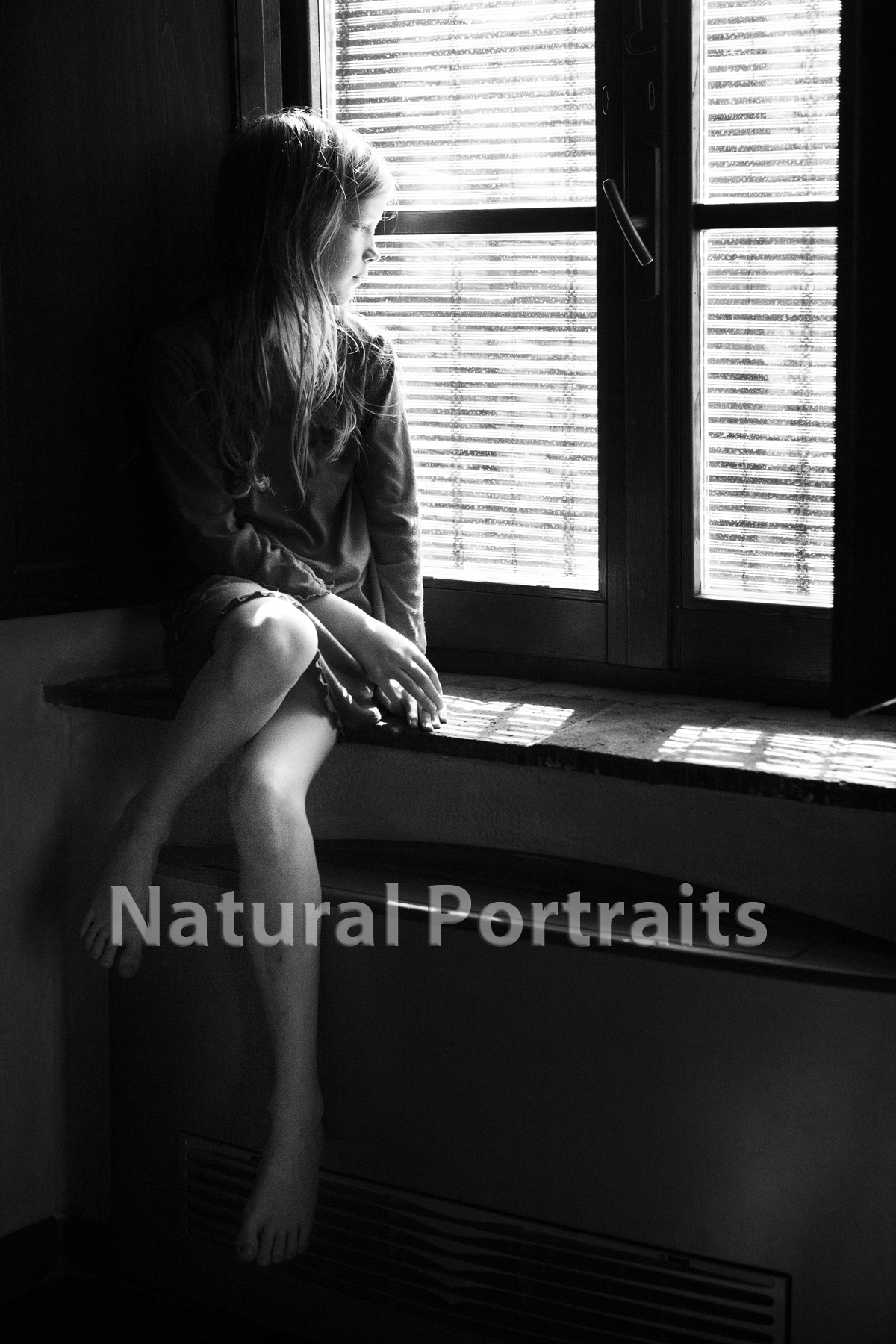 girl at window using low light