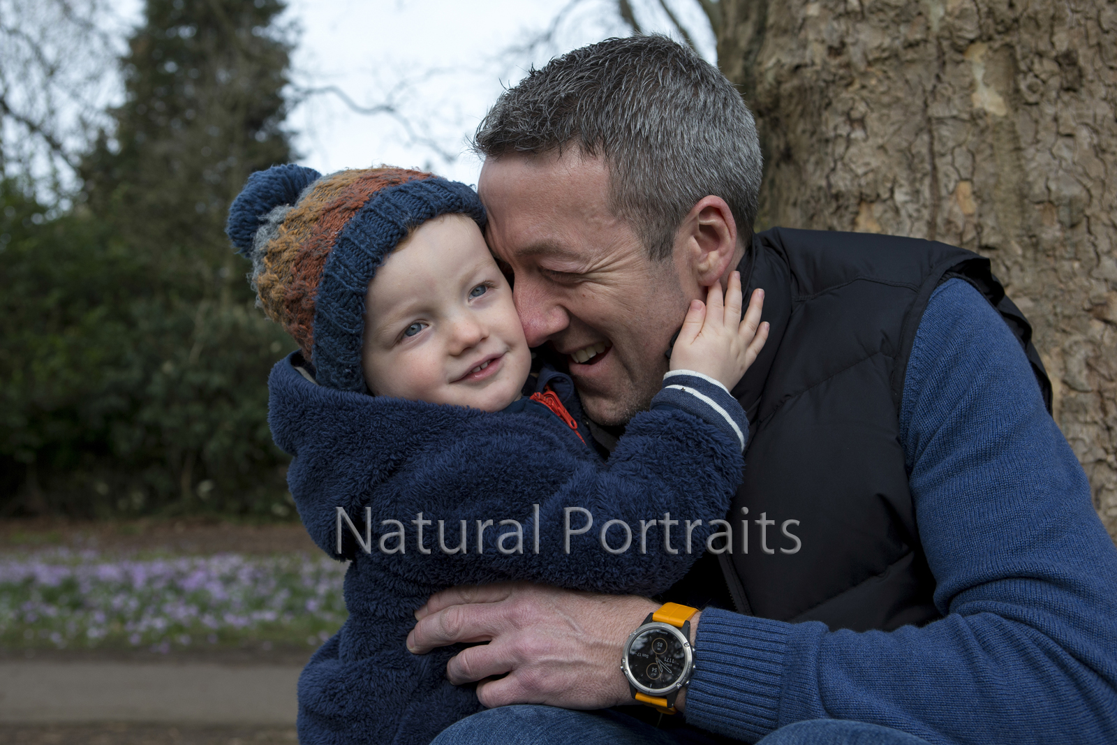Boy hugs dad in Victoria Park, Bath