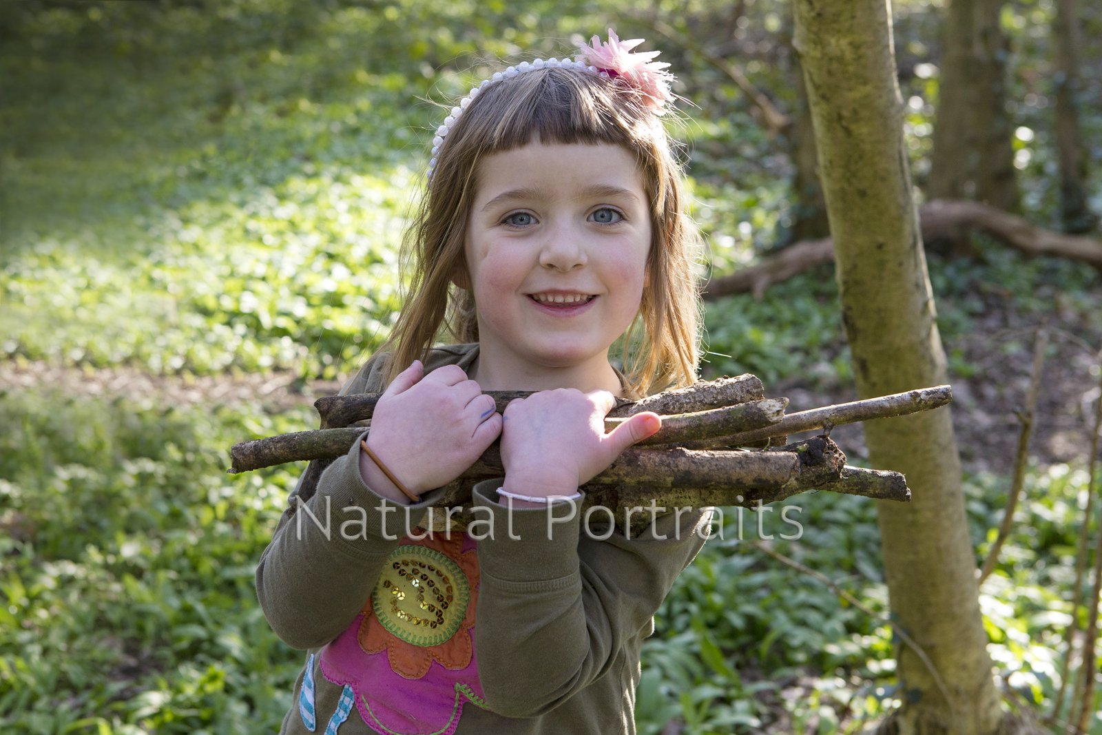 photo of girl carrying sticks
