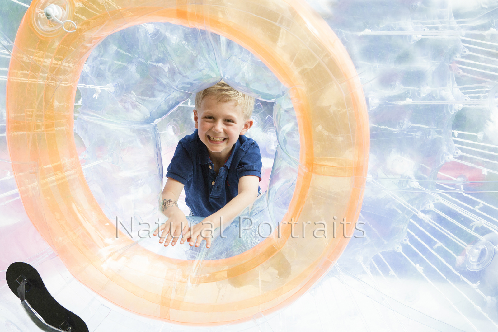 photo of boy in hamster ball